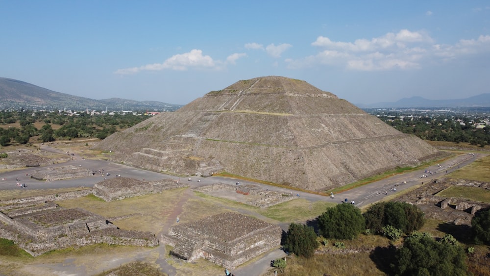 an aerial view of a large pyramid in the middle of a field