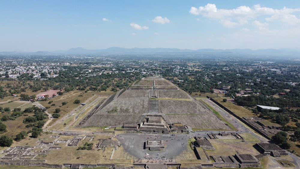 an aerial view of a pyramid in a city