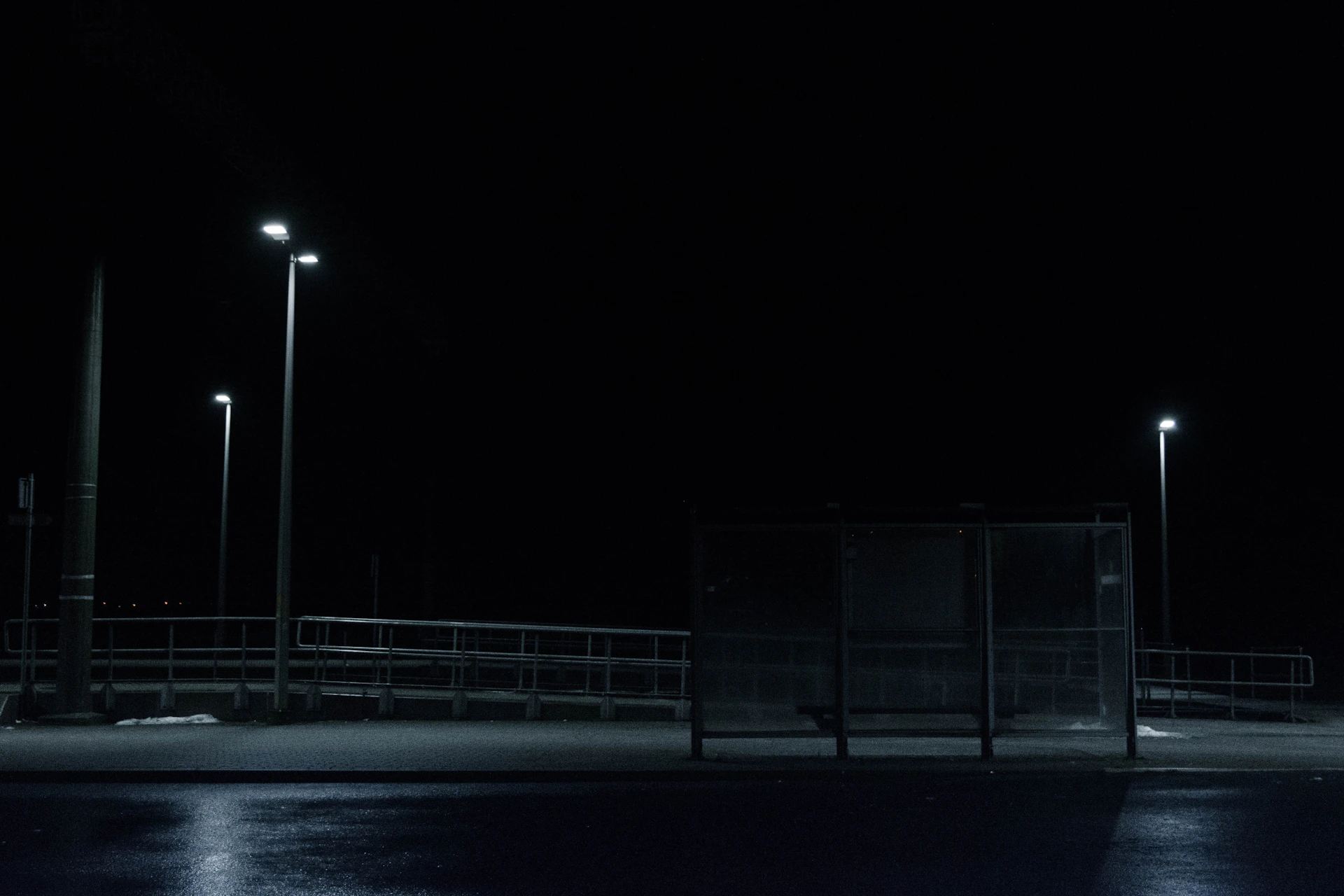 a dark street at night with street lights