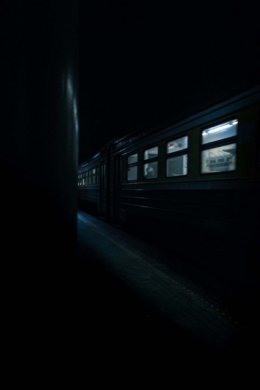 a train traveling down train tracks at night