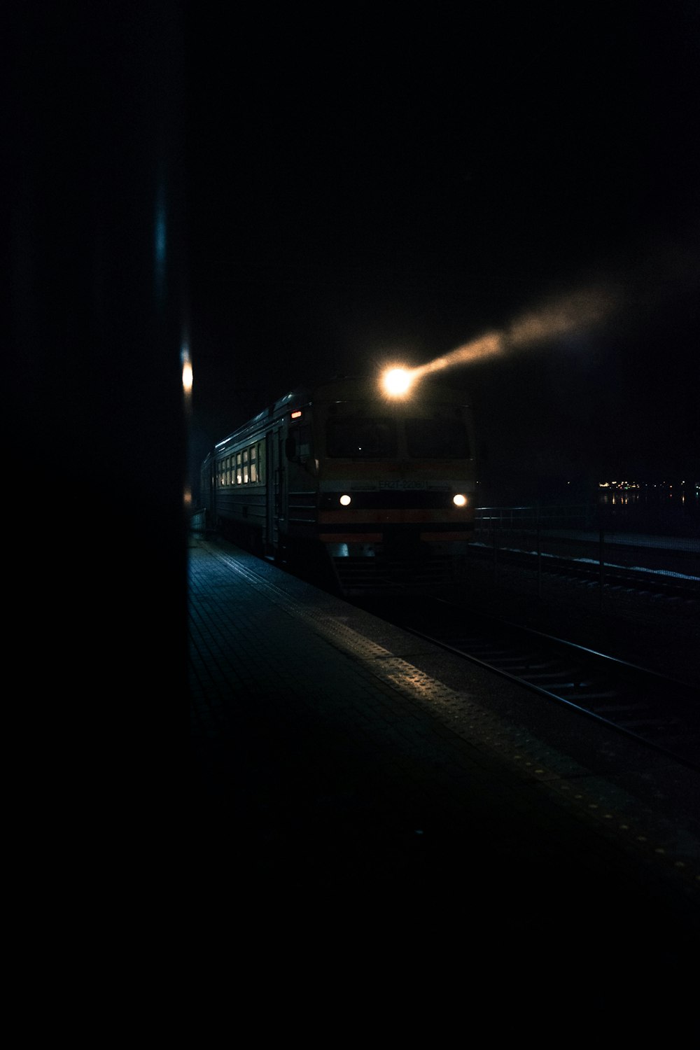 a train traveling down train tracks at night