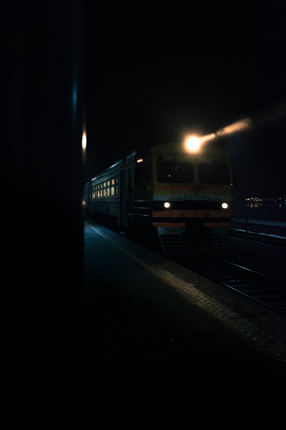 a train traveling down train tracks at night