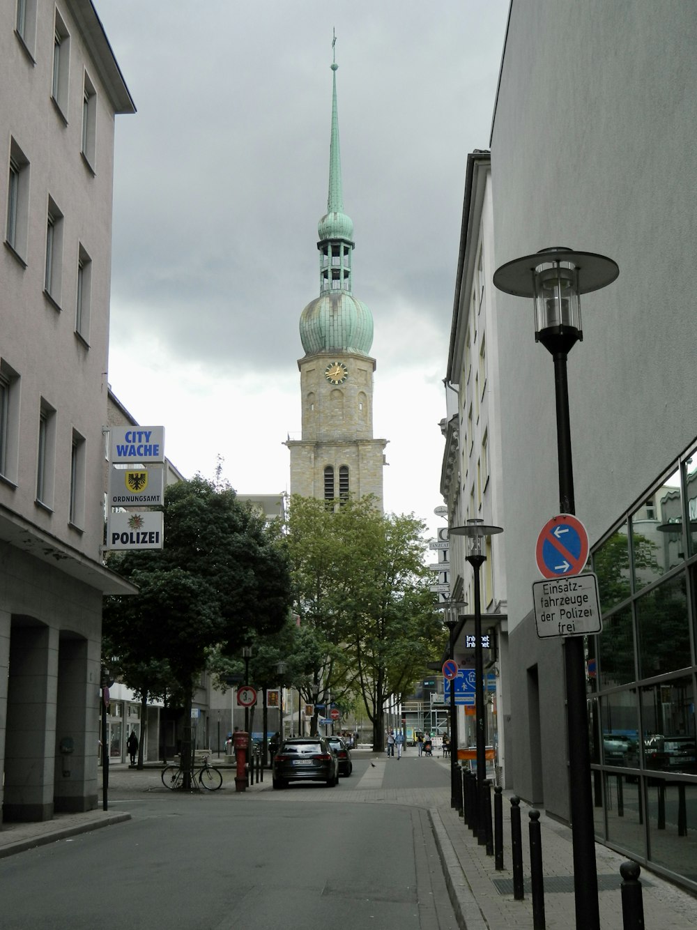 a clock tower towering over a city street