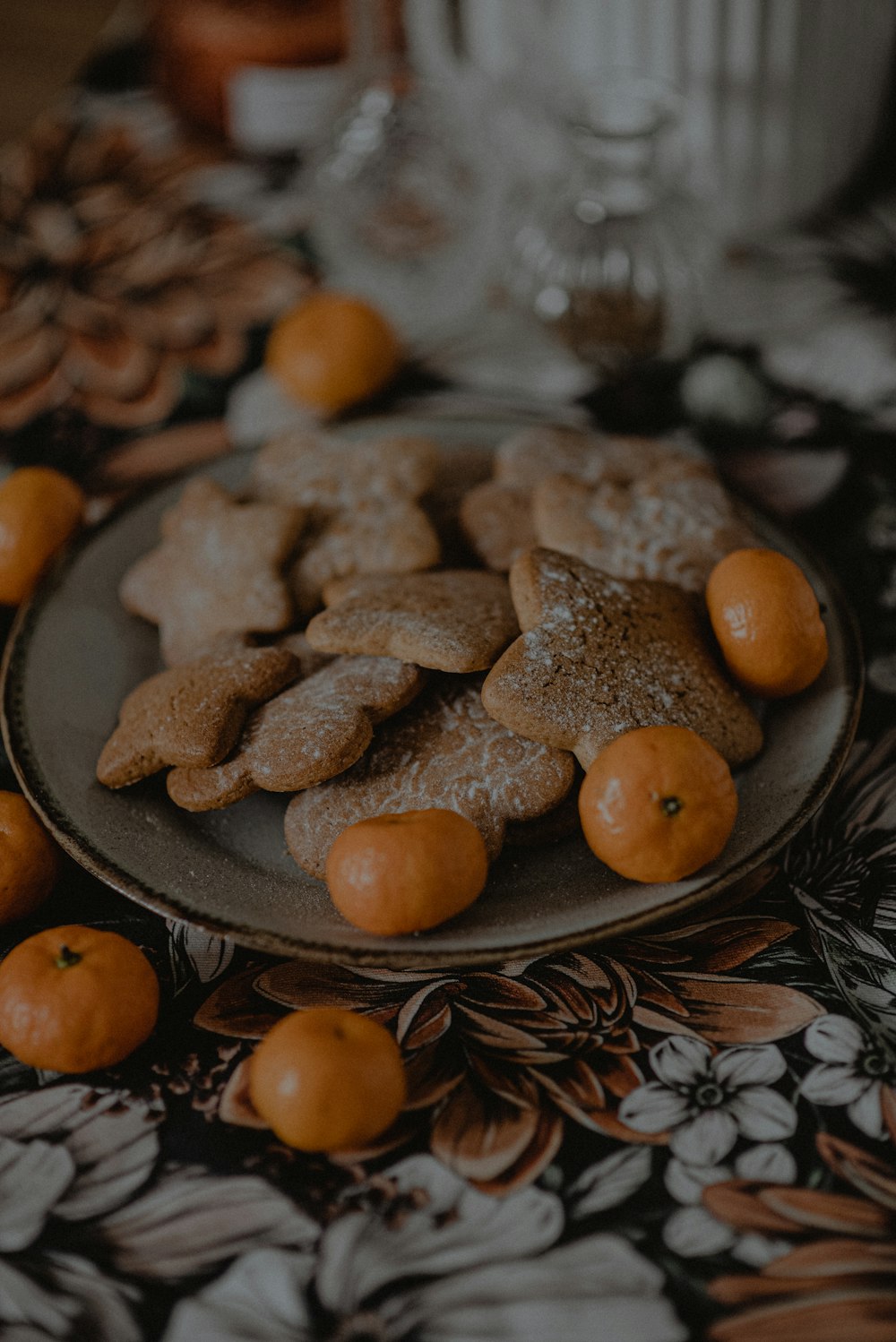 a plate of cookies and oranges on a table