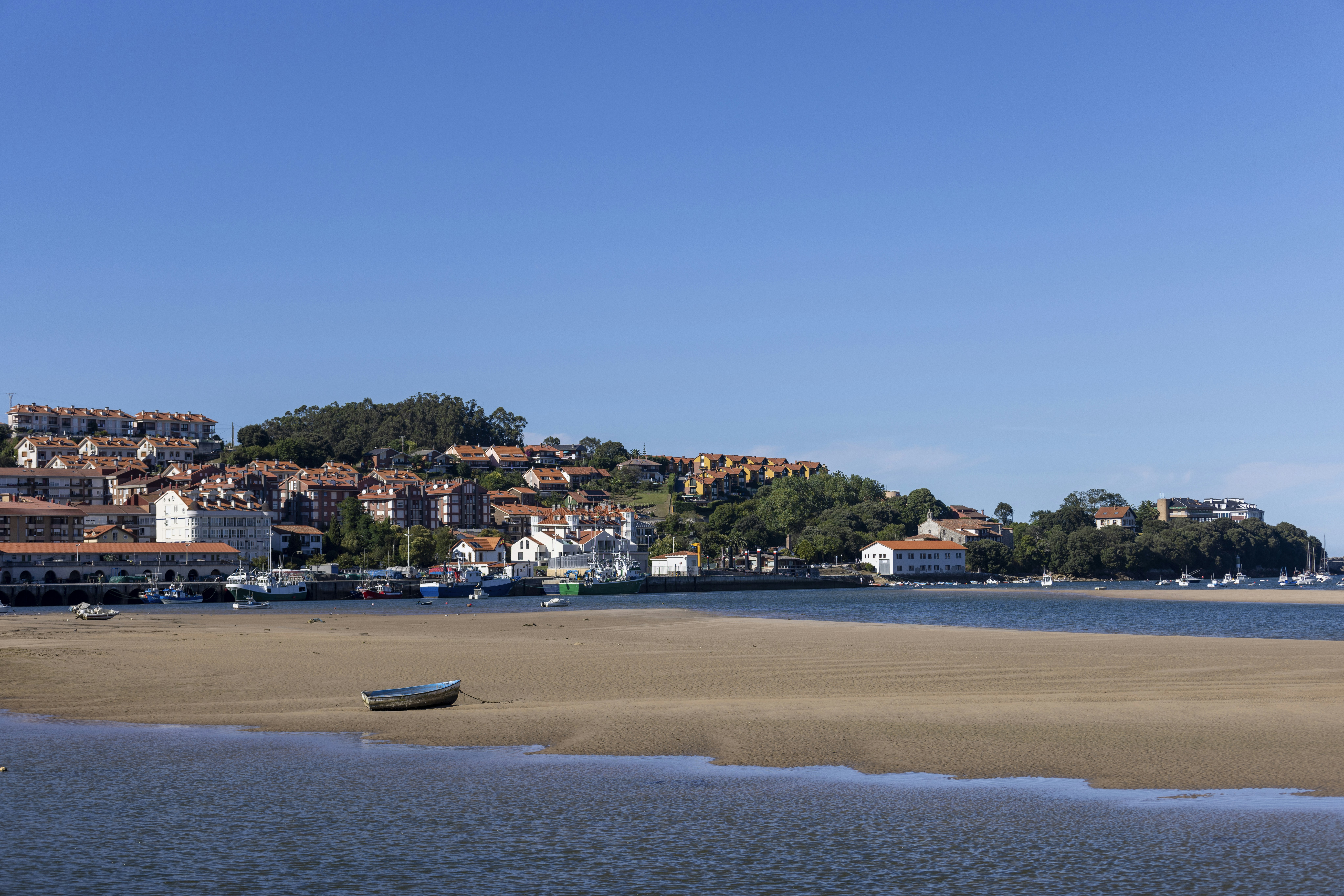 a small boat on the shore of a body of water