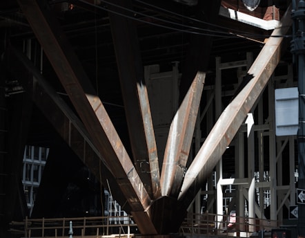 Photo of a structural engineer assessing steel beams on a construction site.