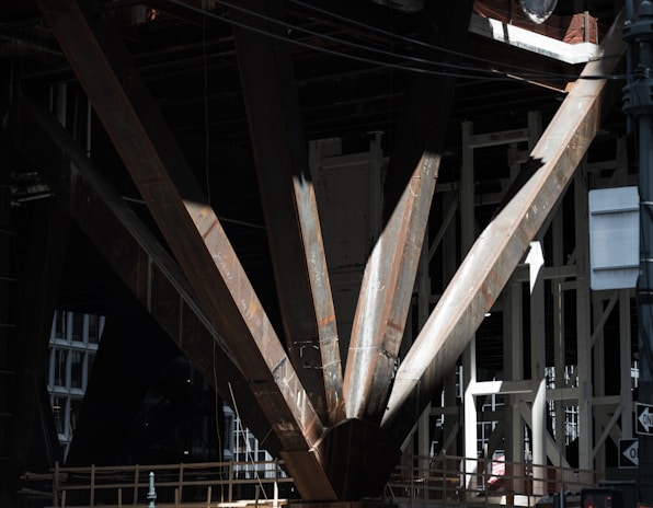Close-up of engineer inspecting structural steel beams with measuring tools.