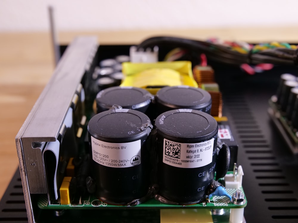 a couple of batteries sitting on top of a motherboard