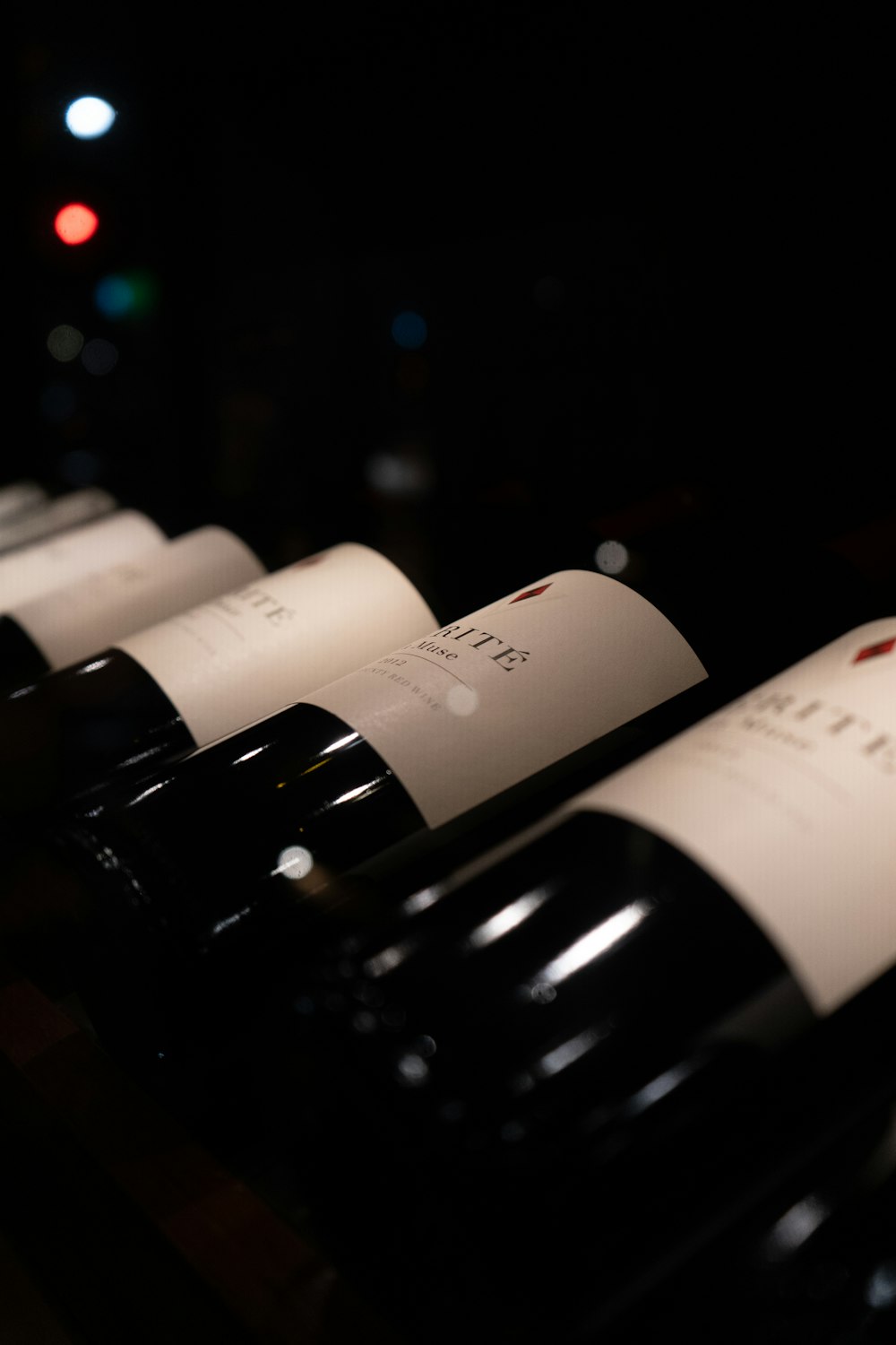 a row of wine bottles sitting on top of a table