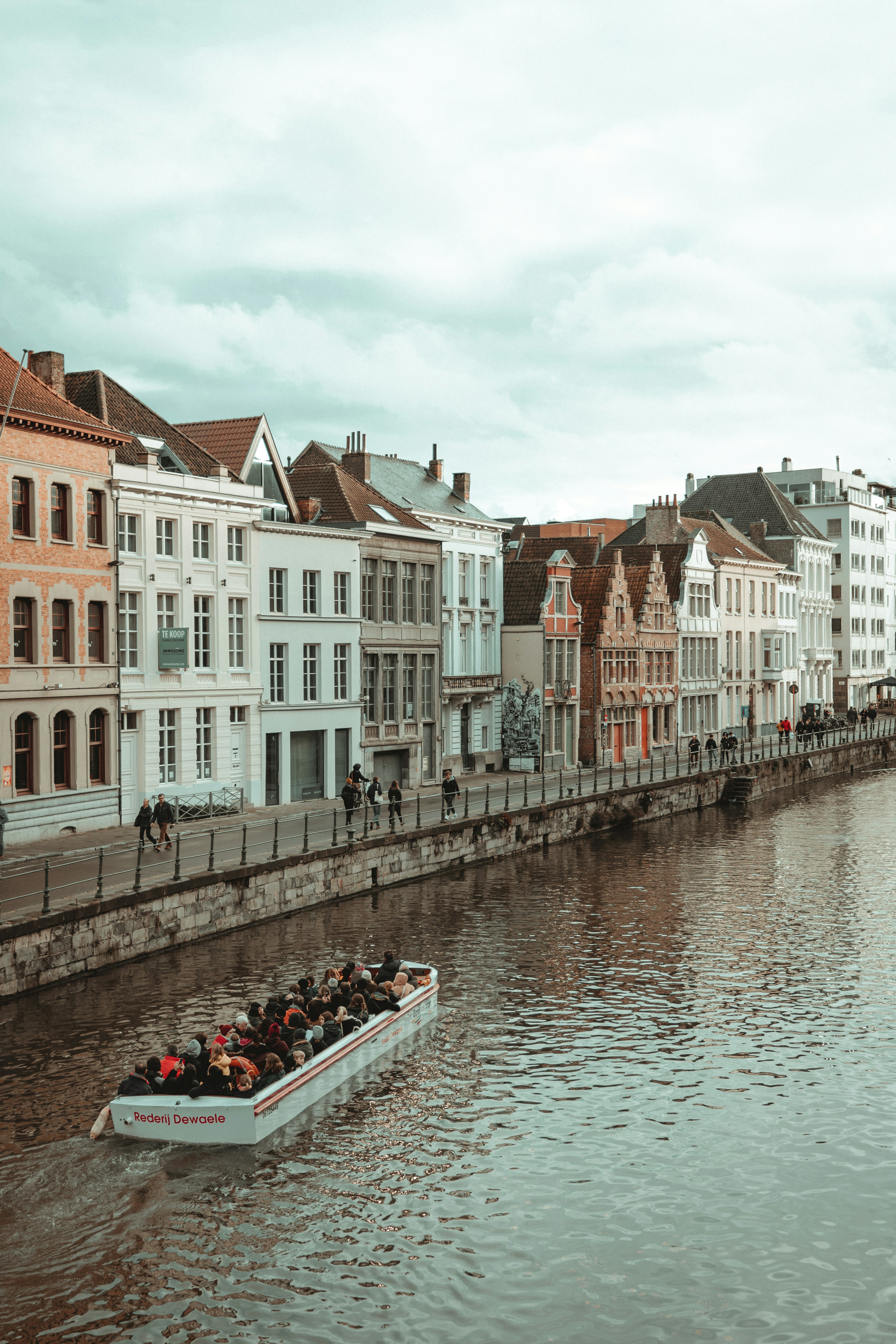 a boat filled with people traveling down a river