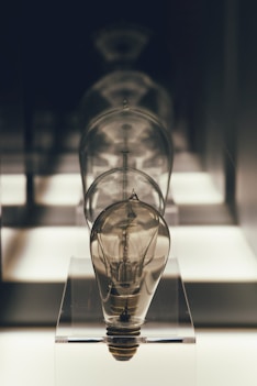 a light bulb sitting on top of a glass stand