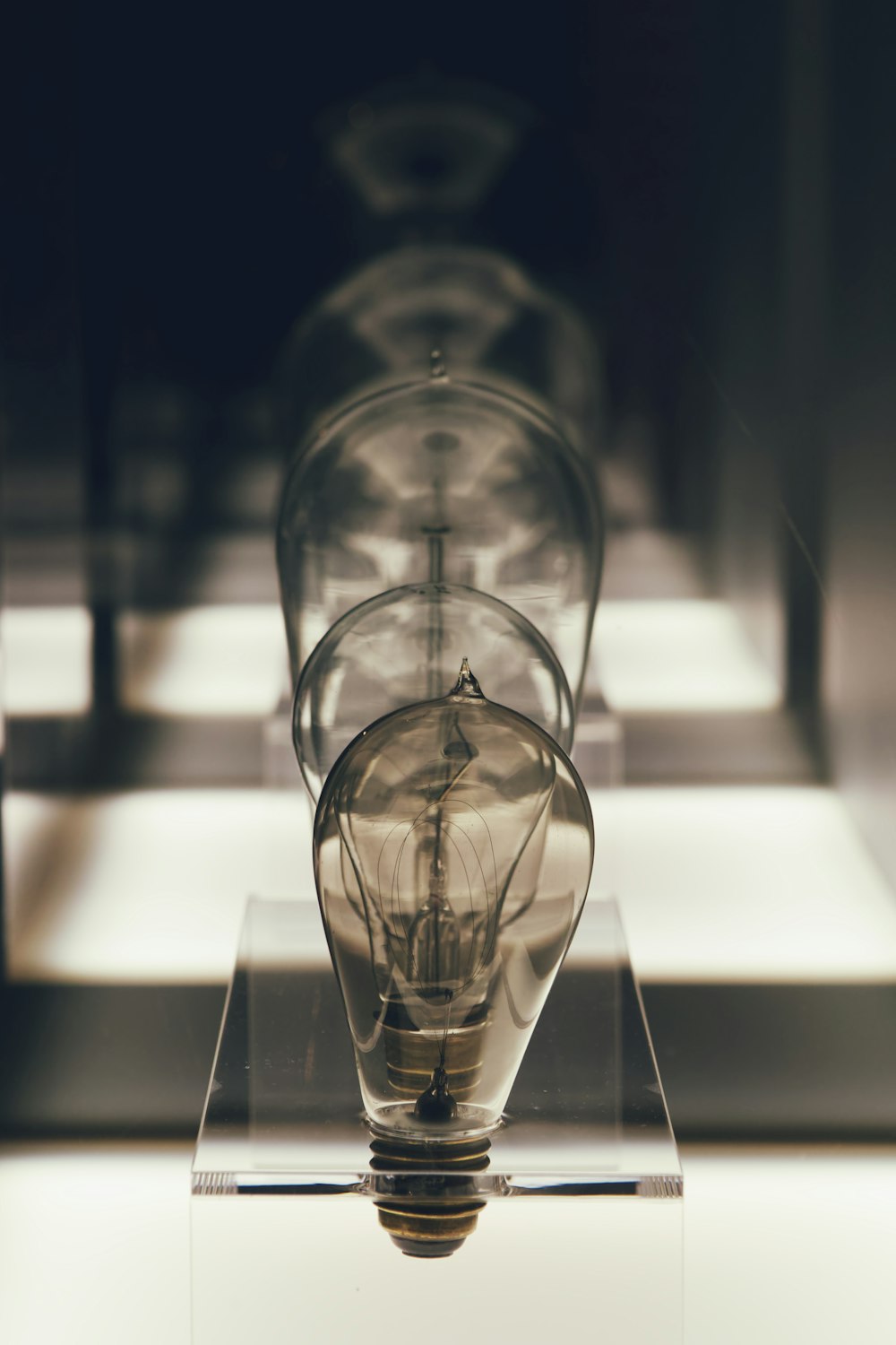 a light bulb sitting on top of a glass stand