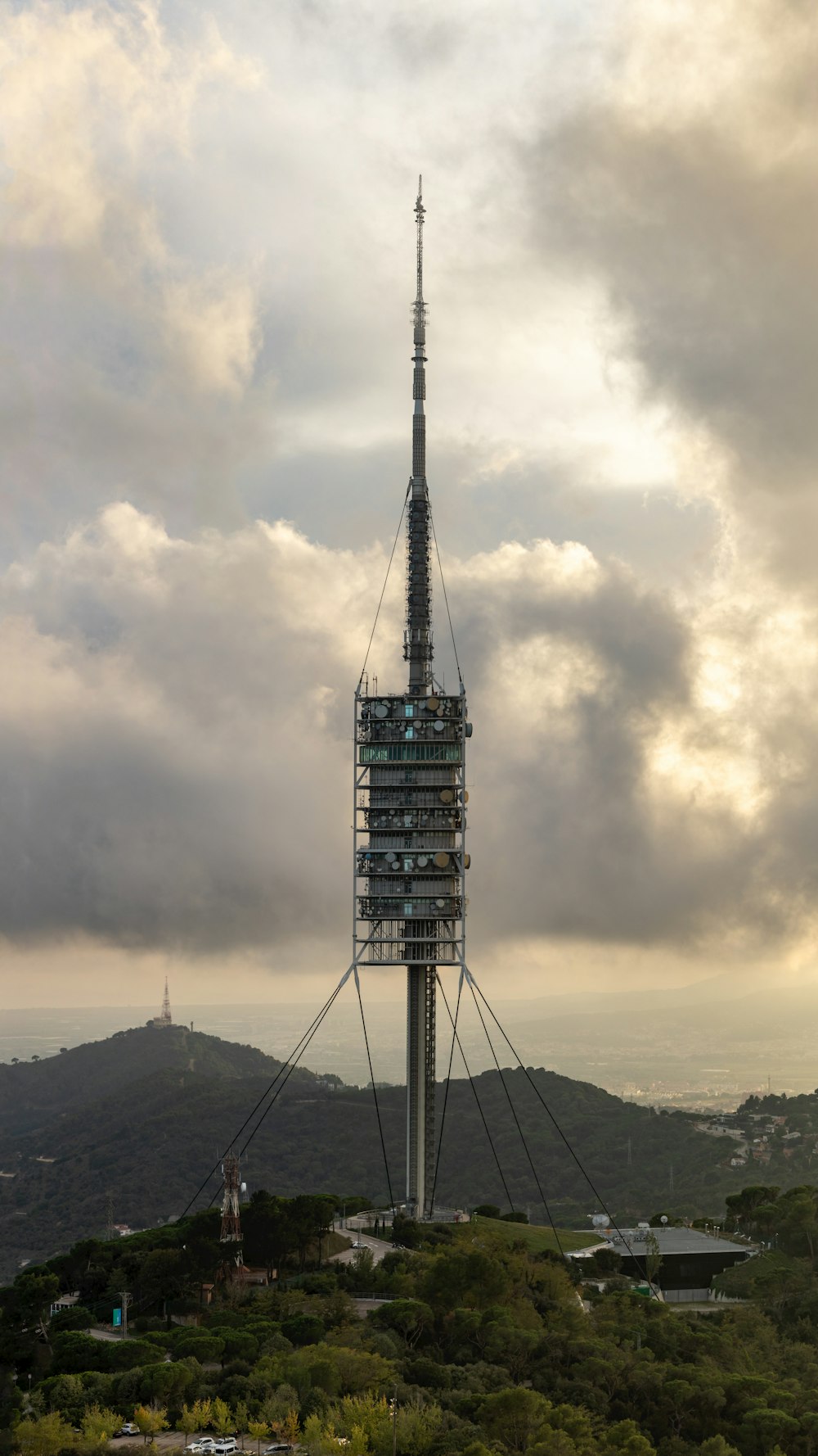 a tall tower sitting on top of a lush green hillside