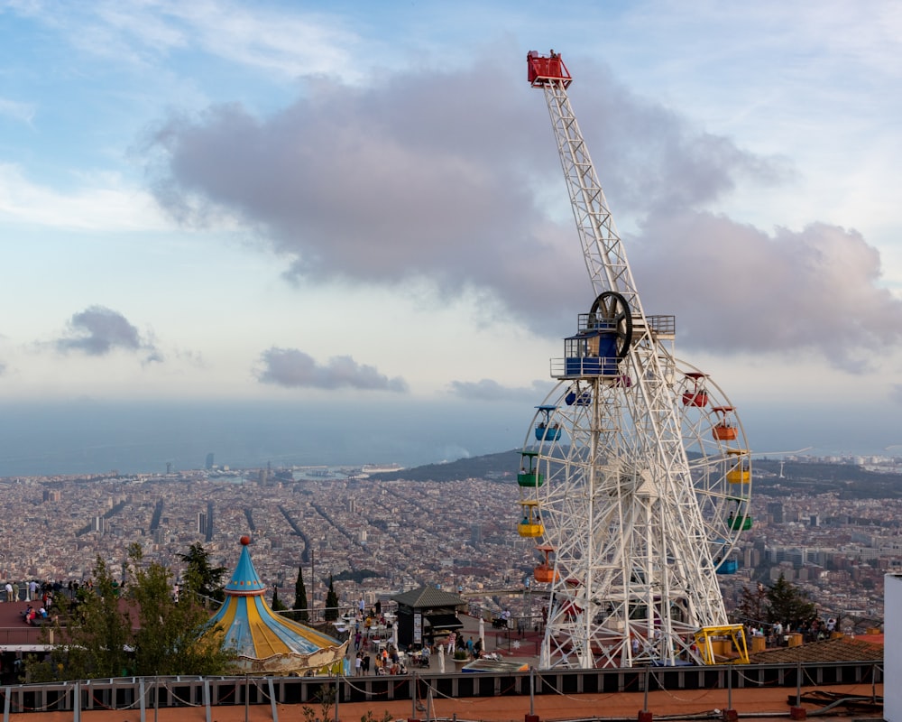 a ferris wheel with a city in the background