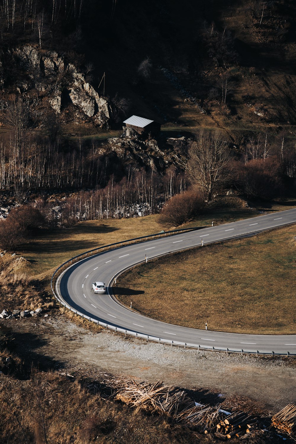 an aerial view of a winding road in the mountains