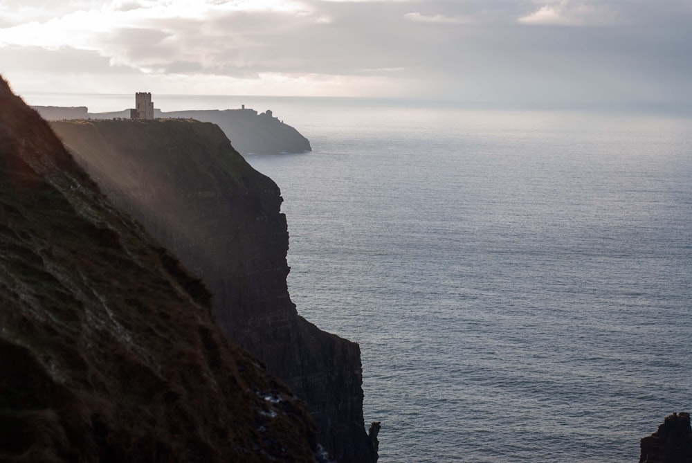 a lighthouse on a cliff overlooking the ocean