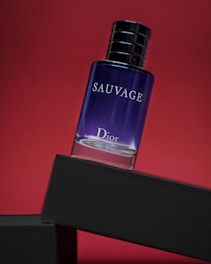 a bottle of perfume sitting on top of a shelf