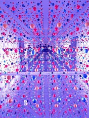 View of a dark blue corridor lined with glowing orbs.