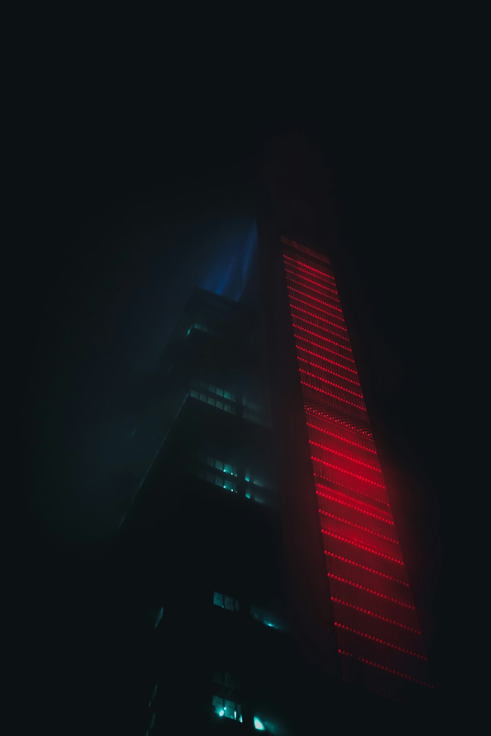 a tall building with a red light on it's side