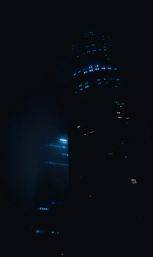 a very tall building lit up in the dark