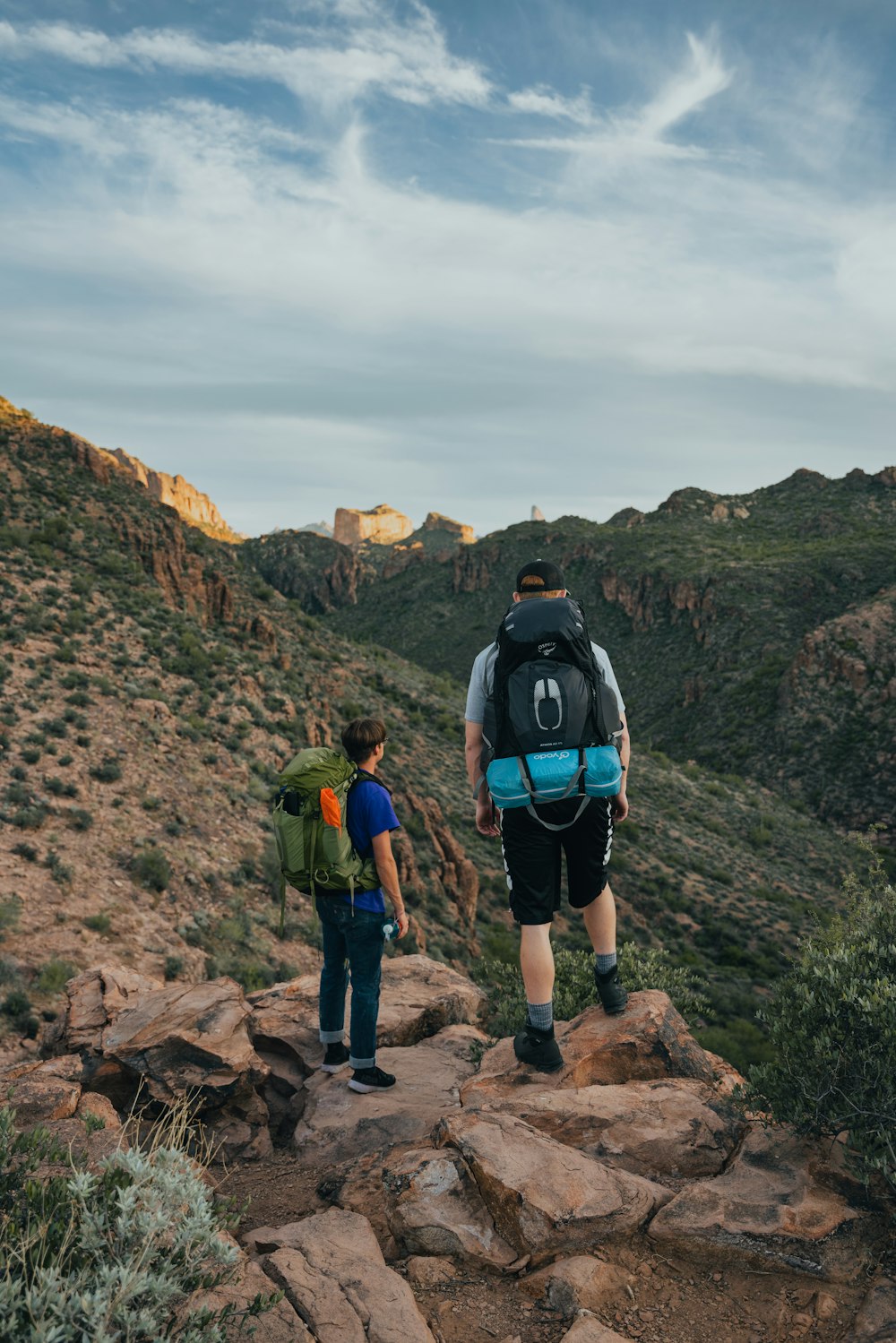 a man and a boy hiking up a mountain