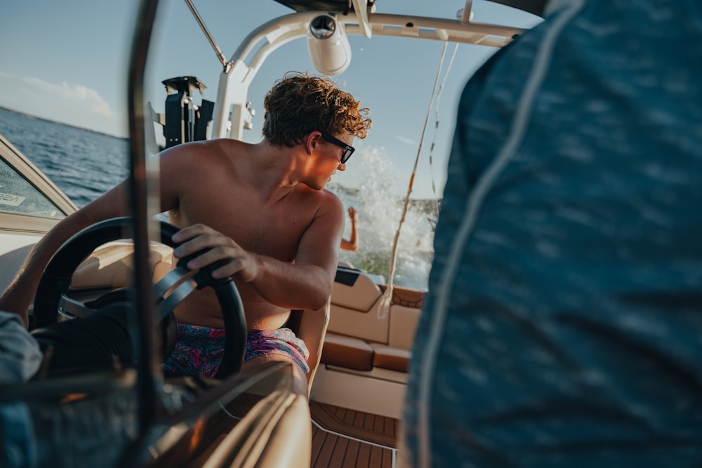 a man driving a boat on a body of water