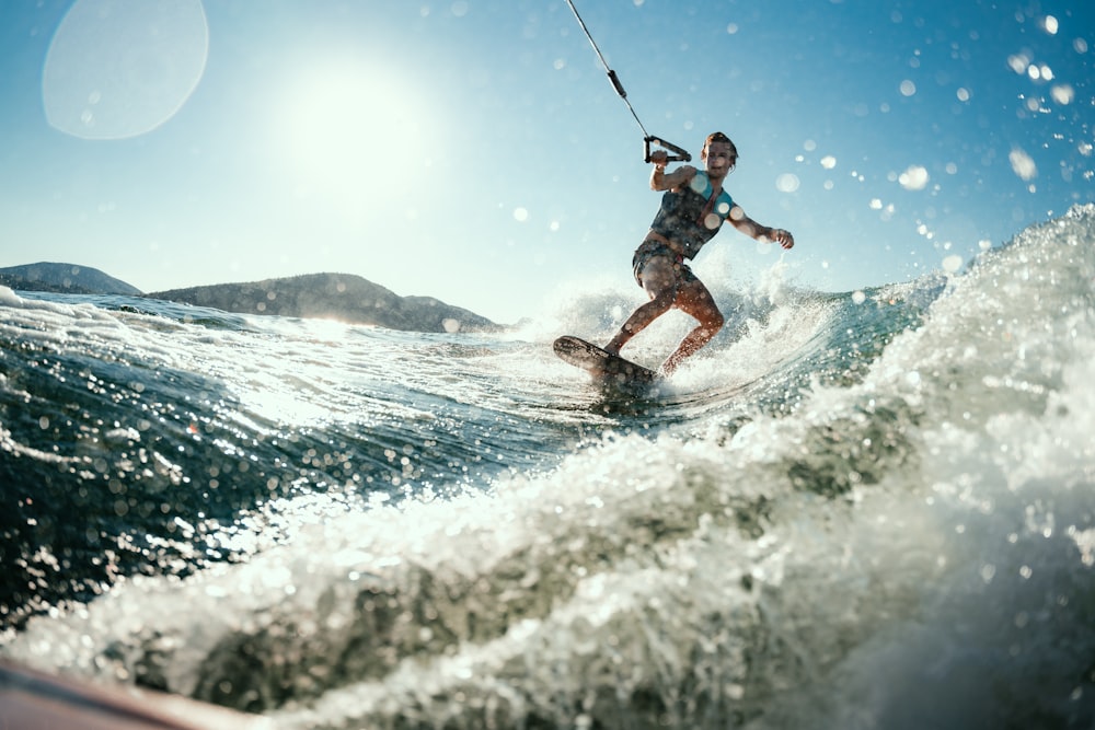 a man riding a wave on top of a surfboard