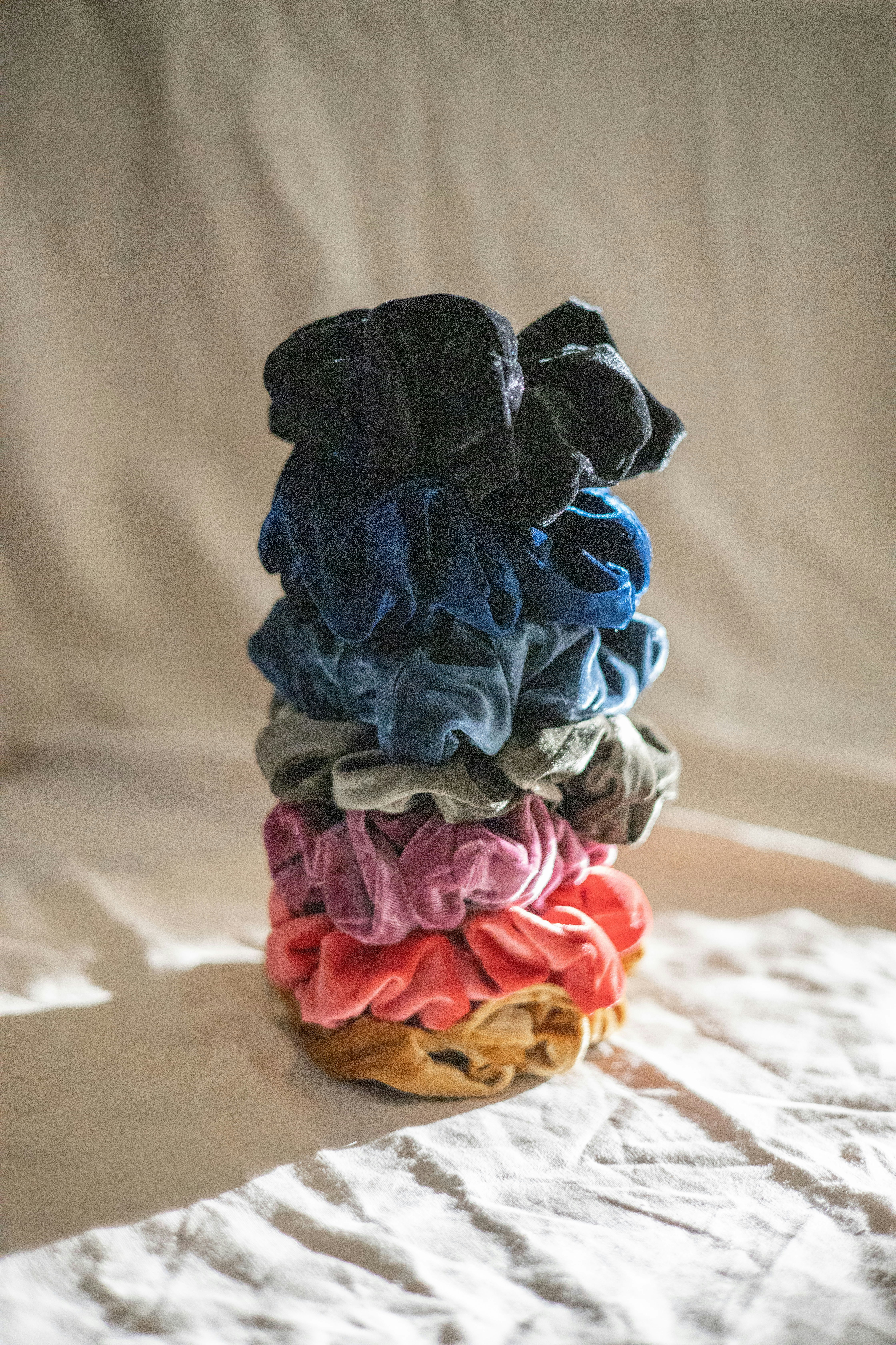 a stack of cloths sitting on top of a bed