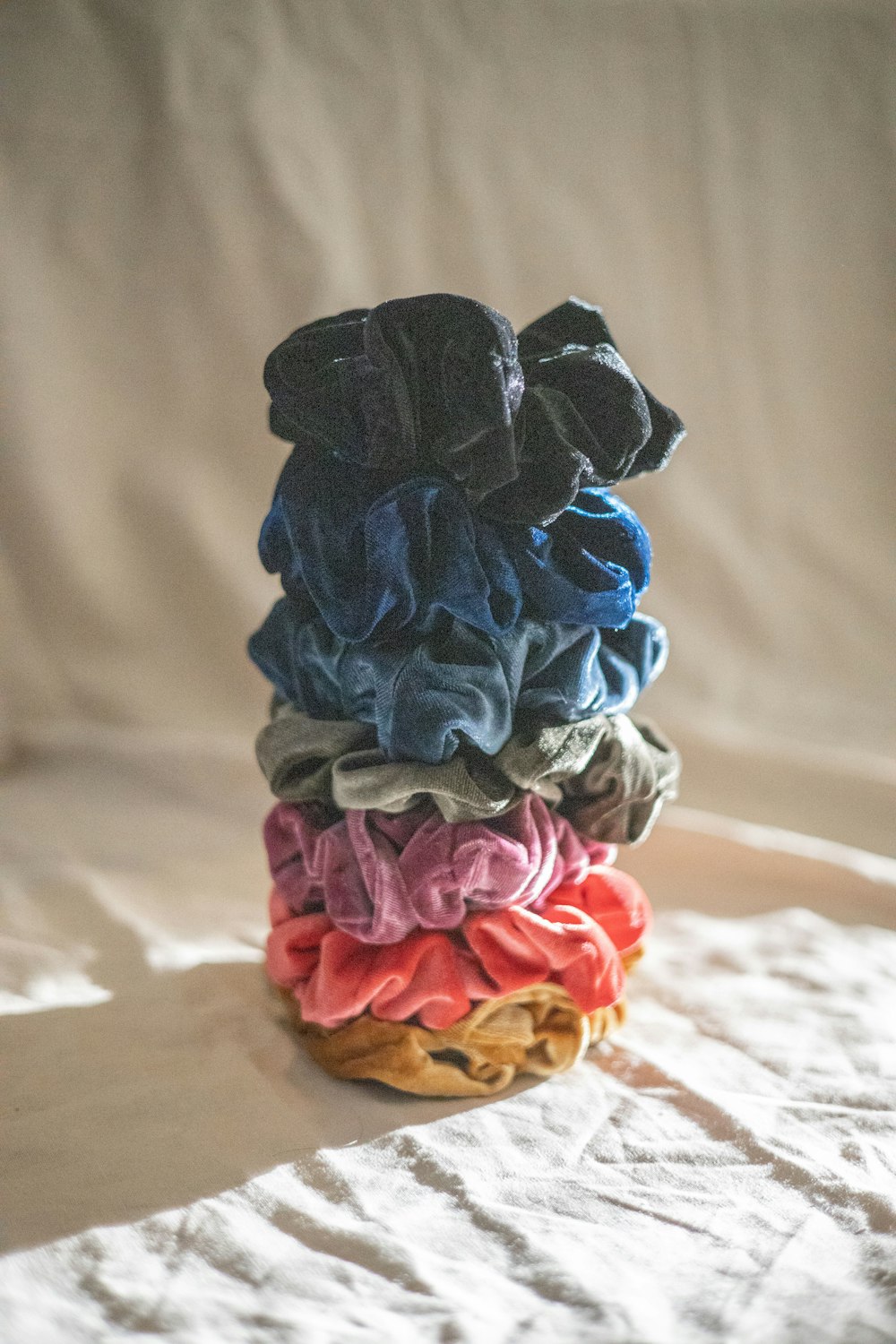a stack of cloths sitting on top of a bed