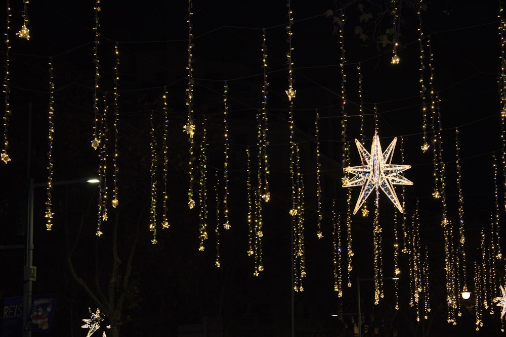 a lighted star hanging from a string of lights