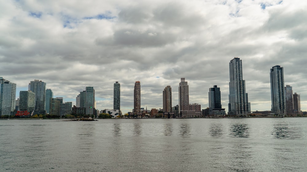 a large body of water with a city in the background