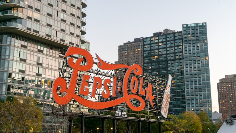 a large coca cola sign on top of a building