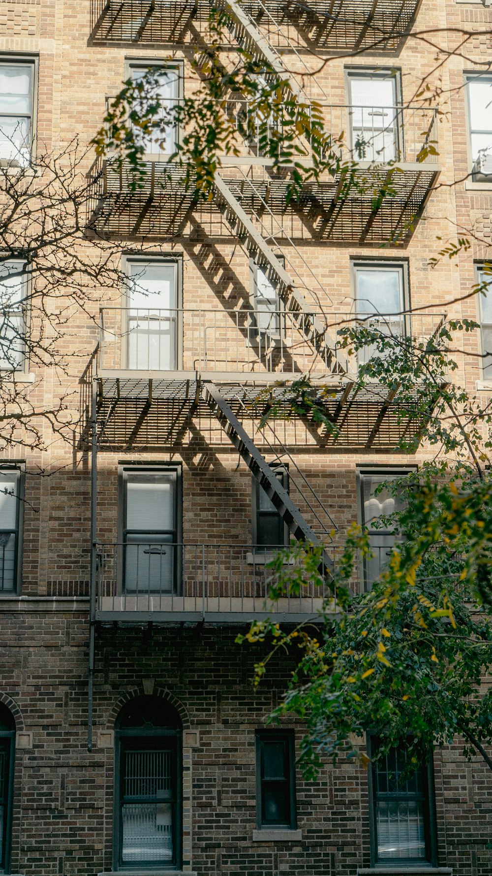 a tall brick building with a fire escape