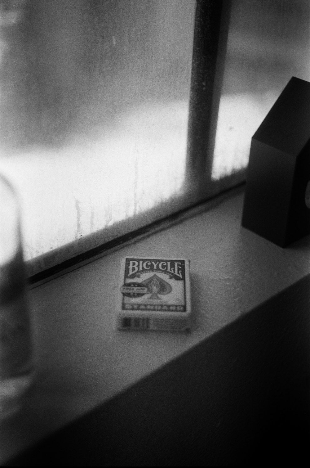 a box of cigarettes sitting on top of a window sill