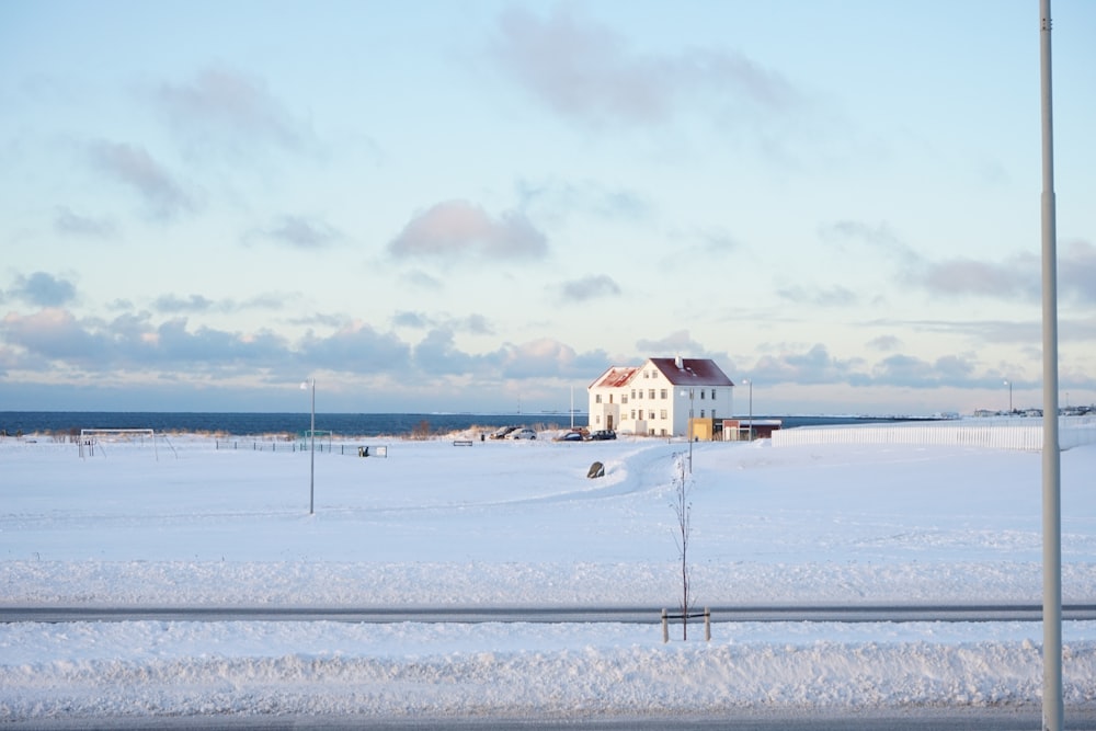 a white house sitting on top of a snow covered field