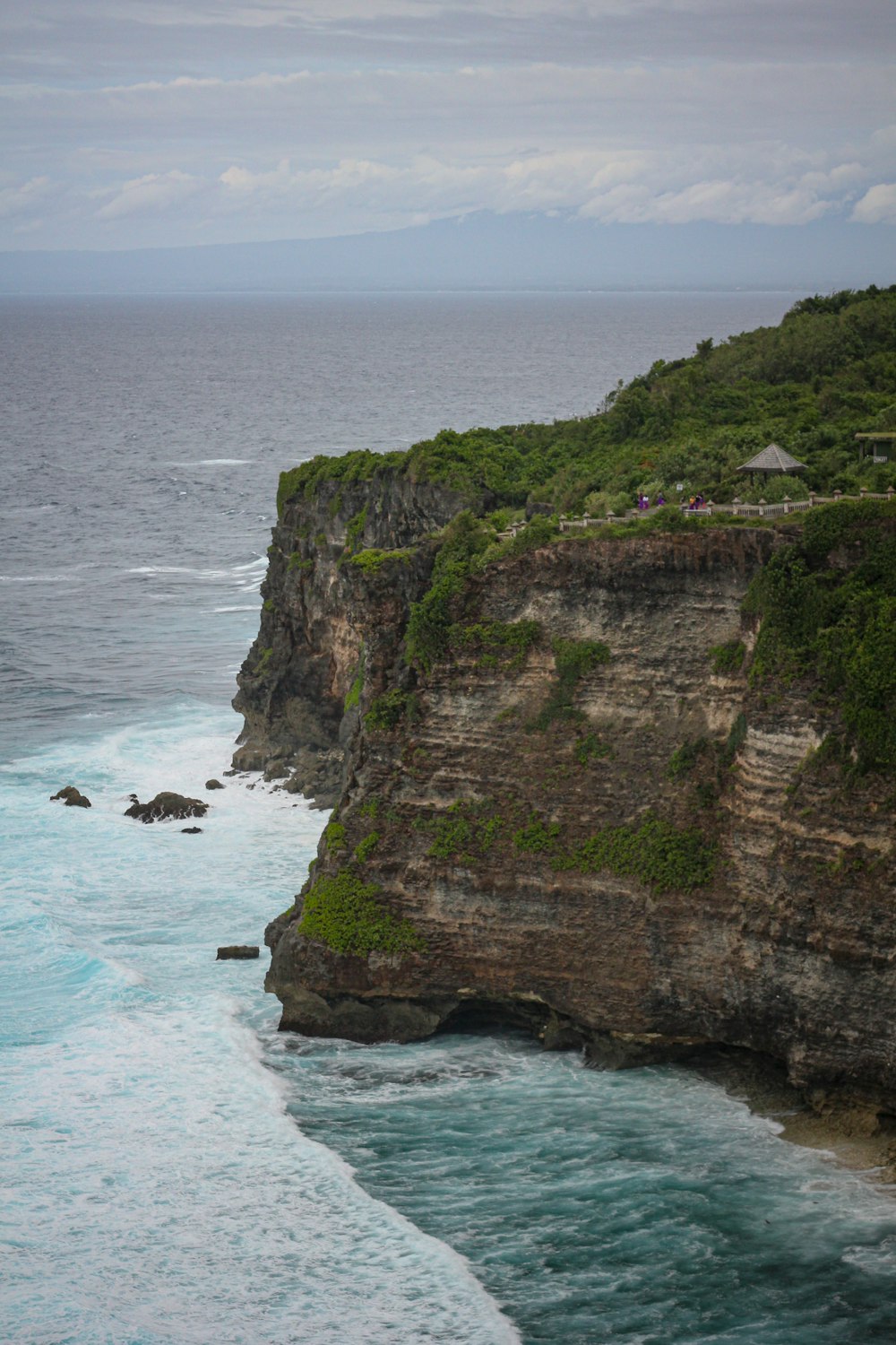 a large body of water next to a cliff