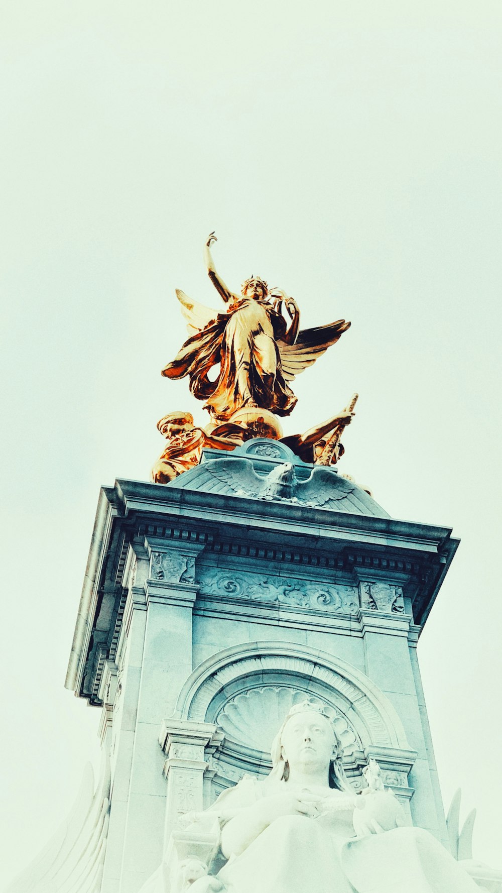 a statue of an angel on top of a building