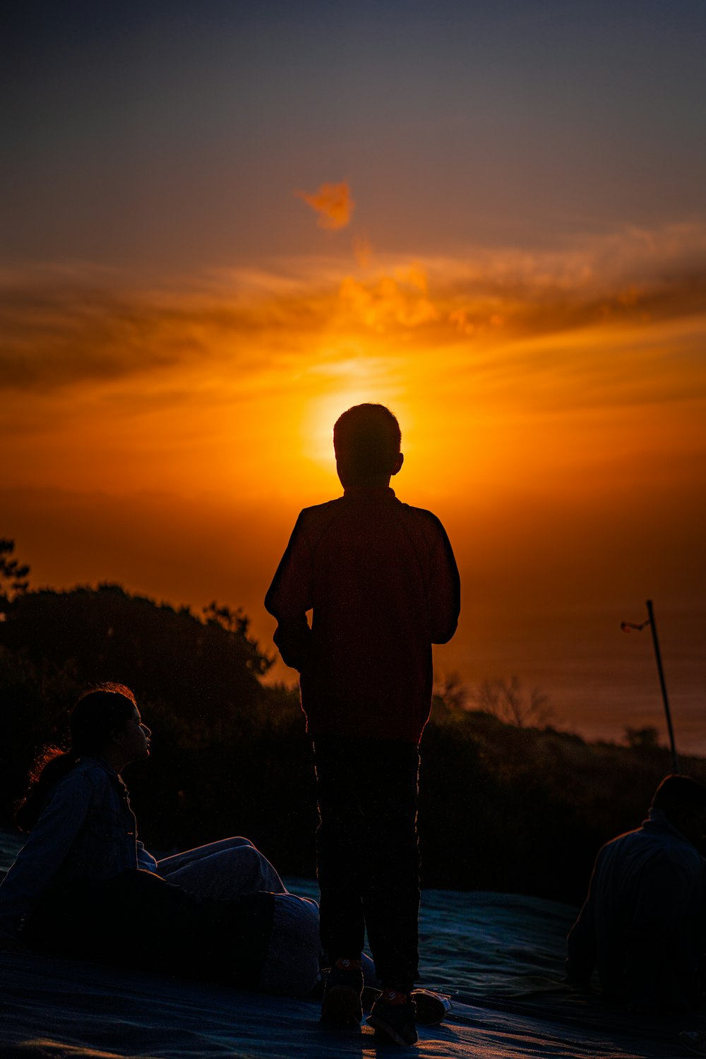 a person standing in front of a sunset