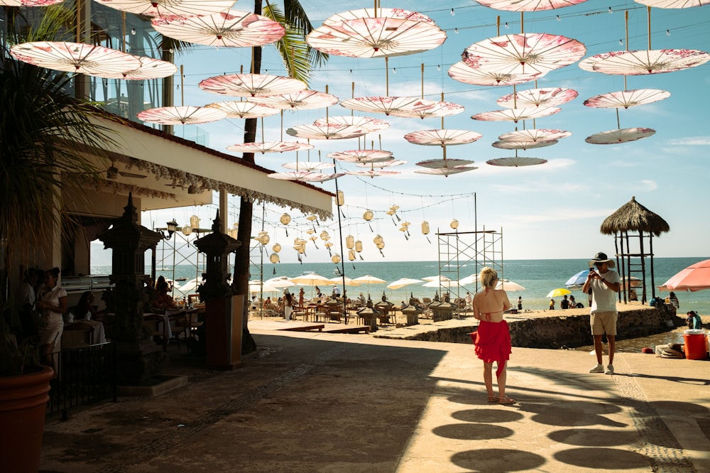 a couple of people that are standing under umbrellas