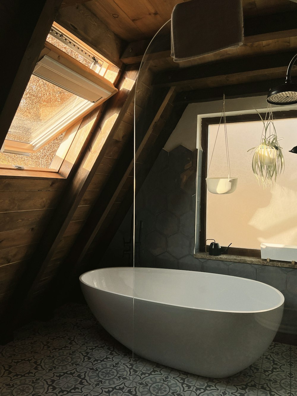 a large white bath tub sitting in a bathroom next to a window