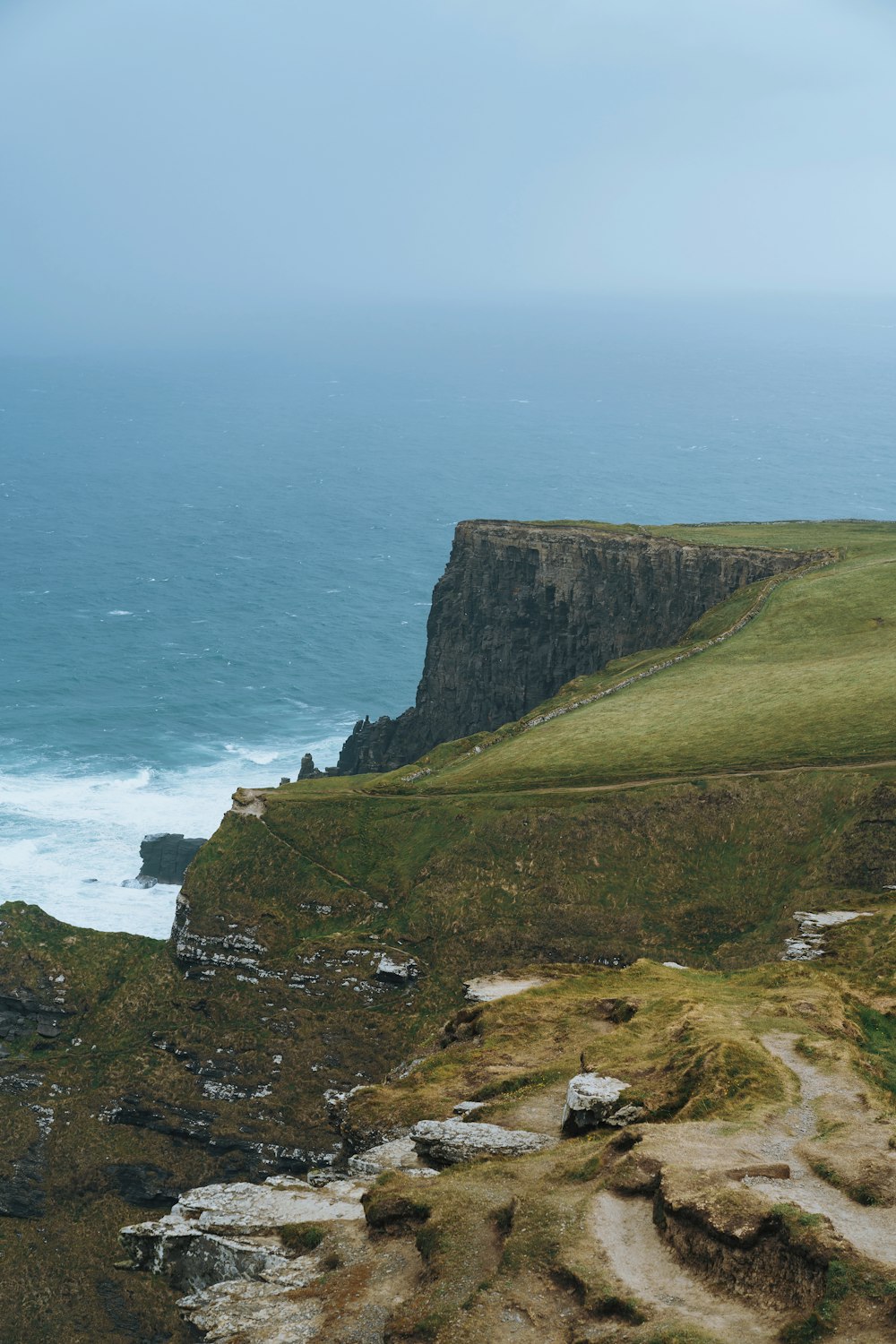 a view of the ocean from the top of a hill