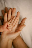 a person holding a baby in their hands