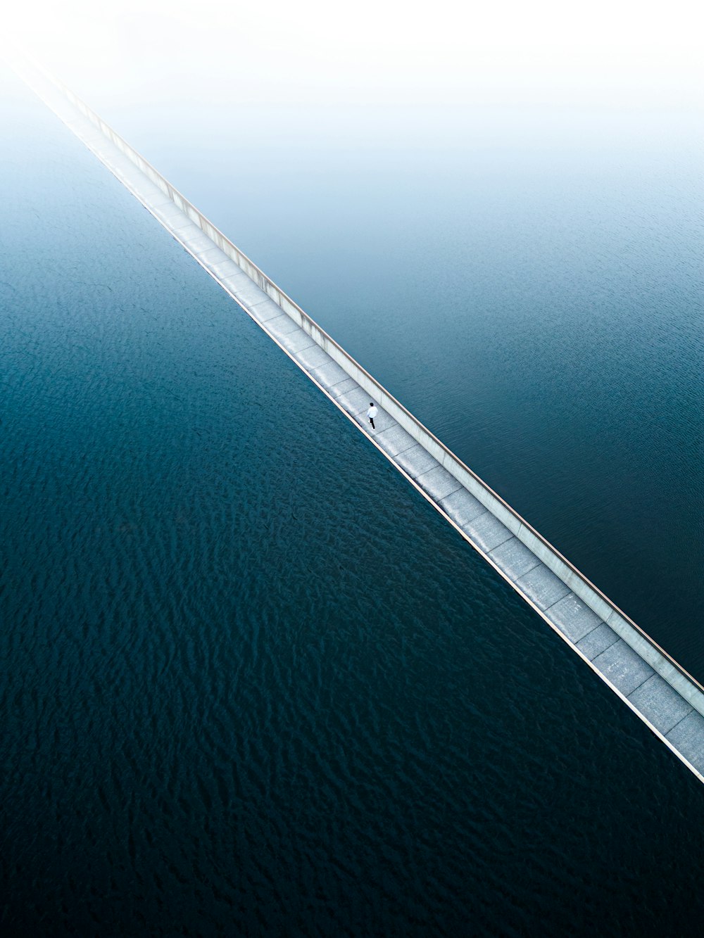 an aerial view of a bridge over a body of water