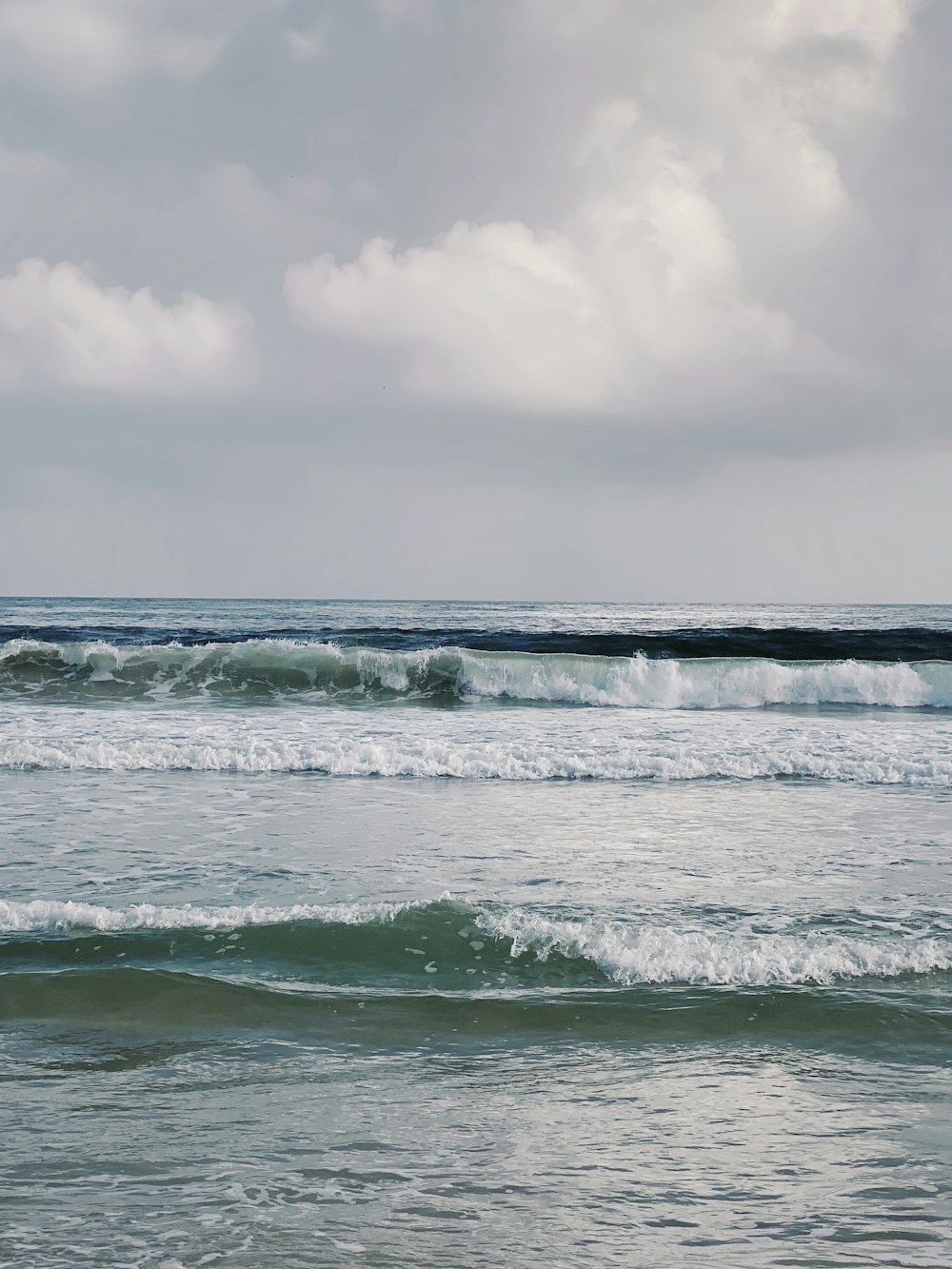 a person riding a surfboard on a wave in the ocean