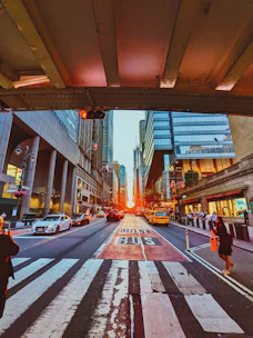 Technicians installing intelligent transport system devices on urban roads at sunset.