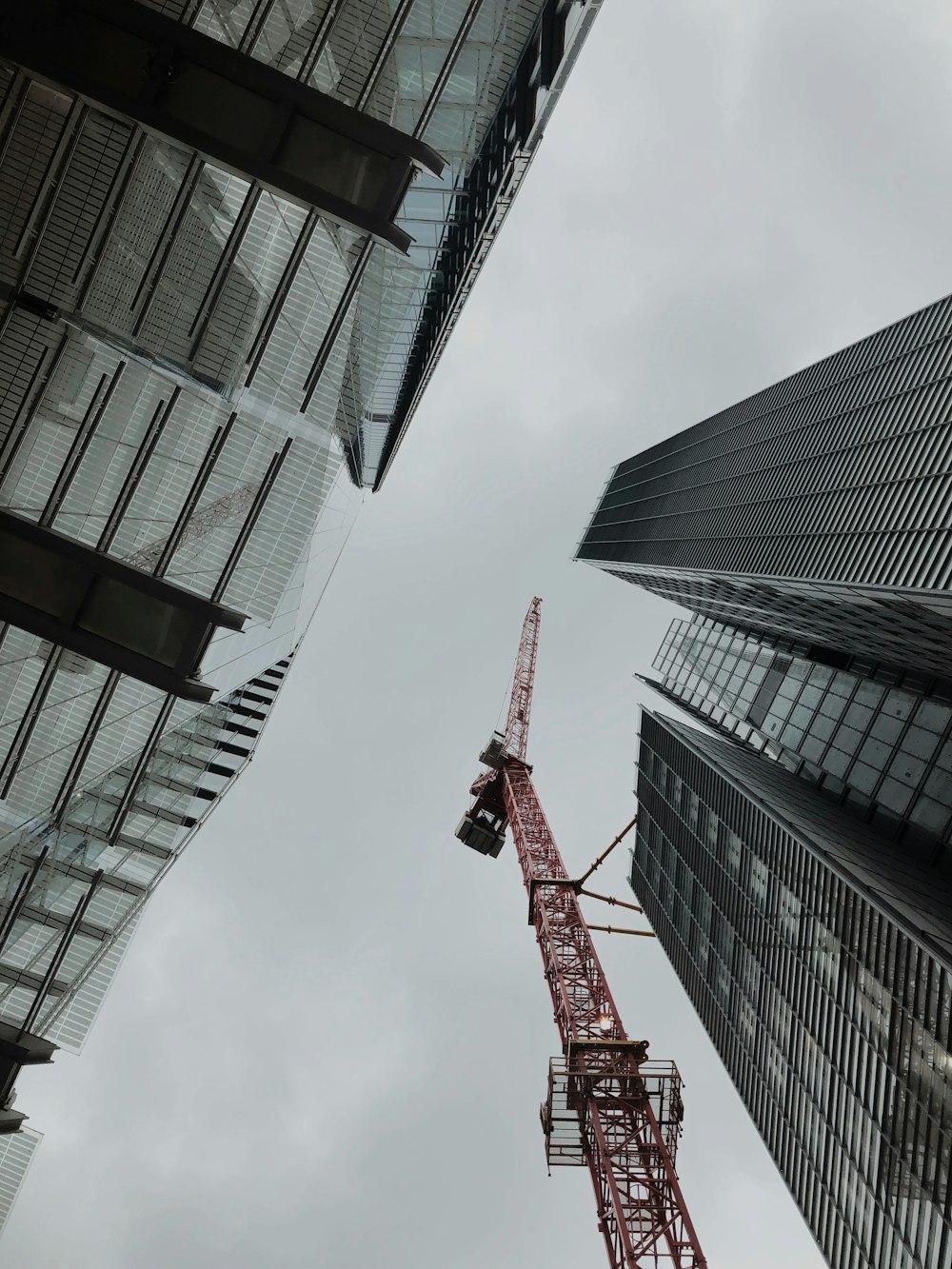 a crane is in between two tall buildings