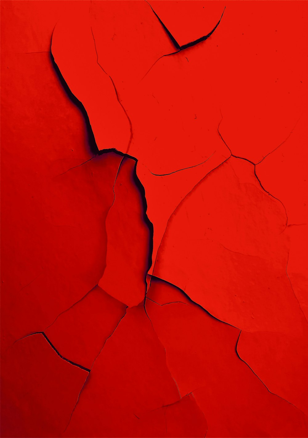 a red wall with a crack in it