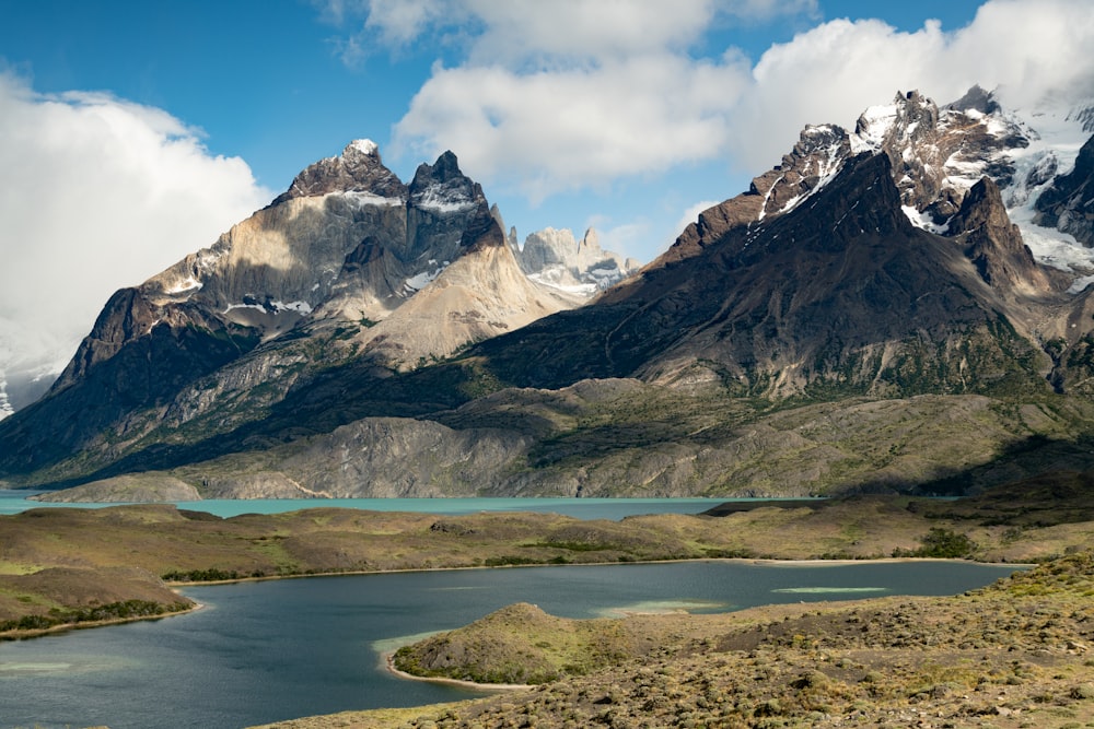 a mountain range with a body of water in the foreground