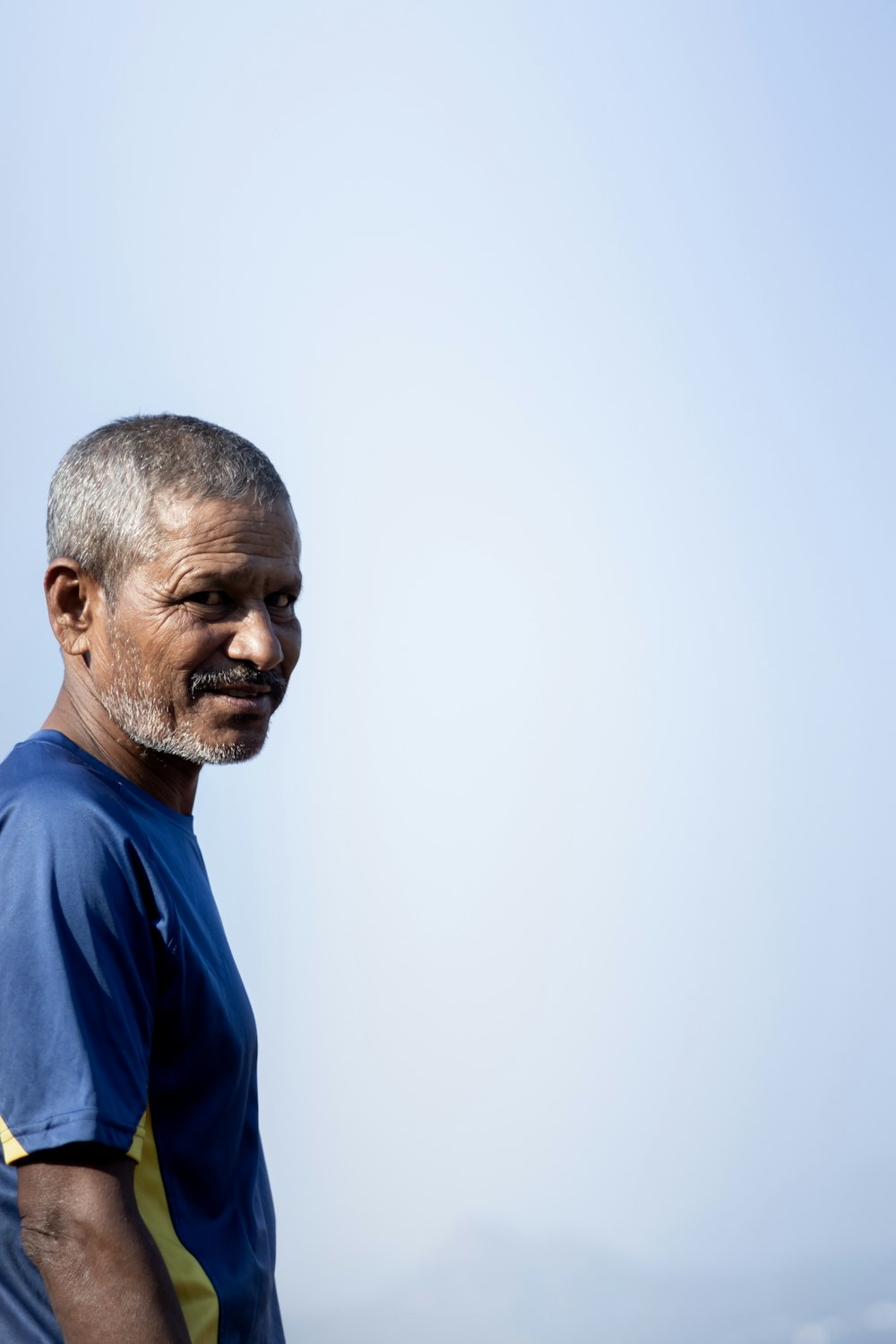 a man with a beard and a blue shirt