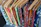 Close-up of a handloon saree's intricate patterns and vivid colors displayed on a wooden hanger.